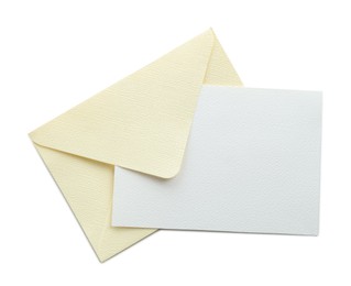 Photo of Blank invitation card and envelope isolated on white, top view. Space for design