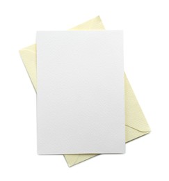 Photo of Blank invitation card and envelope isolated on white, top view. Space for design