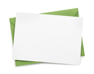 Photo of Blank invitation card and envelope isolated on white, top view. Space for design