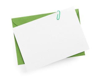 Photo of Blank invitation card and envelope isolated on white, top view. Space for design