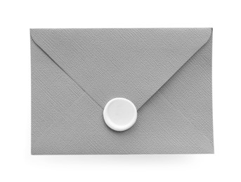 Photo of Beautiful invitation envelope with wax seal isolated on white, top view