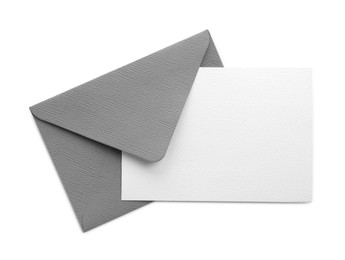 Photo of Blank invitation card and envelope isolated on white, top view. Space for design