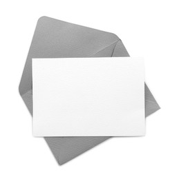Photo of Blank invitation card and envelope isolated on white, top view. Space for design
