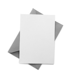 Photo of Blank invitation card and envelope isolated on white, top view. Space for design