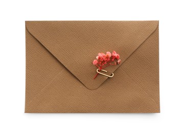 Photo of Beautiful invitation envelope with flower isolated on white, top view