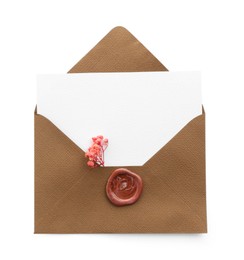 Photo of Blank invitation card and envelope with flower isolated on white, top view. Space for design