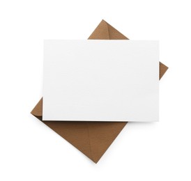 Photo of Blank invitation card and envelope isolated on white, top view. Space for design