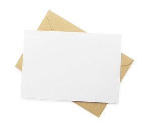 Photo of Blank invitation card and envelope isolated on white, top view. Space for design