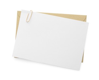 Photo of Blank invitation card and envelope isolated on white, top view. Space for design