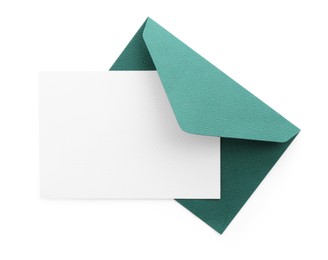 Photo of Blank invitation card and envelope isolated on white, top view. Space for design