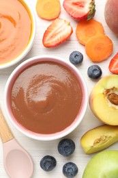 Photo of Baby food. Tasty puree in bowls and different ingredients on white wooden table, flat lay
