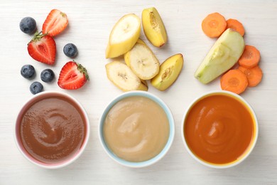 Photo of Baby food. Tasty puree in bowls and different ingredients on white wooden table, flat lay
