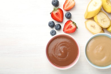 Photo of Baby food. Tasty puree in bowls and different ingredients on white wooden table, flat lay