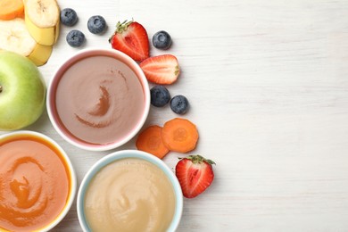 Photo of Baby food. Tasty puree in bowls and different ingredients on white wooden table, flat lay. Space for text