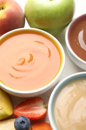 Photo of Baby food. Tasty puree in bowls and different ingredients on table, above view