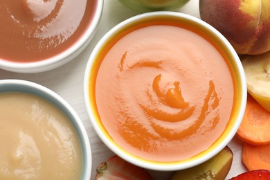 Photo of Baby food. Tasty puree in bowls and different ingredients on table, flat lay