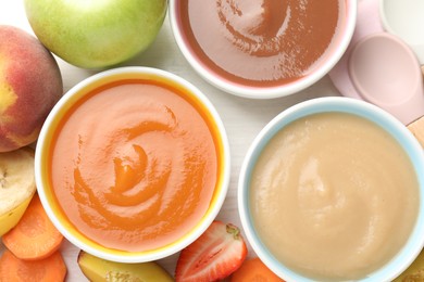Photo of Baby food. Tasty puree in bowls and different ingredients on table, flat lay