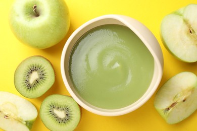 Photo of Baby food. Tasty puree in bowls and different ingredients on yellow background, flat lay