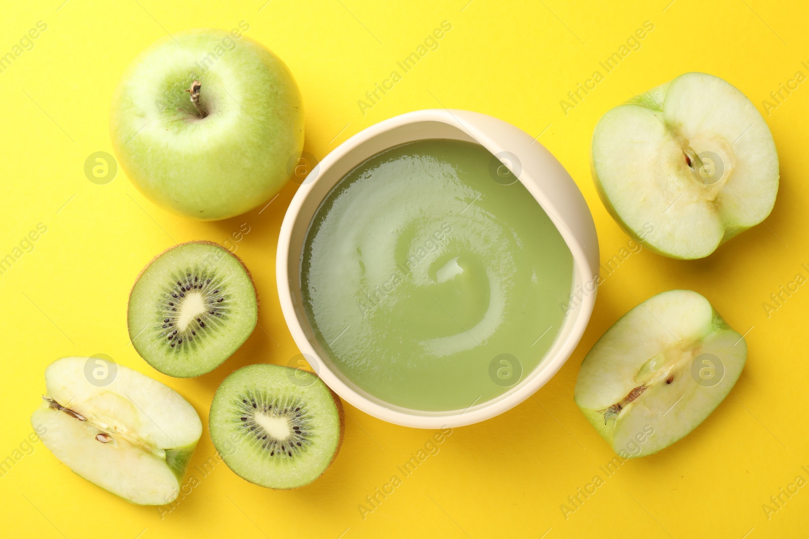 Baby food. Tasty puree in bowls and different ingredients on yellow background, flat lay Photo of Baby food. Tasty puree in bowls and different ingredients on yellow background, flat lay