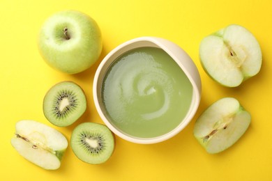 Photo of Baby food. Tasty puree in bowls and different ingredients on yellow background, flat lay