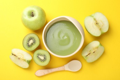 Photo of Baby food. Tasty puree in bowls and different ingredients on yellow background, flat lay