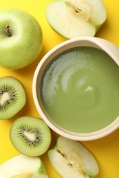 Photo of Baby food. Tasty puree in bowls and different ingredients on yellow background, flat lay