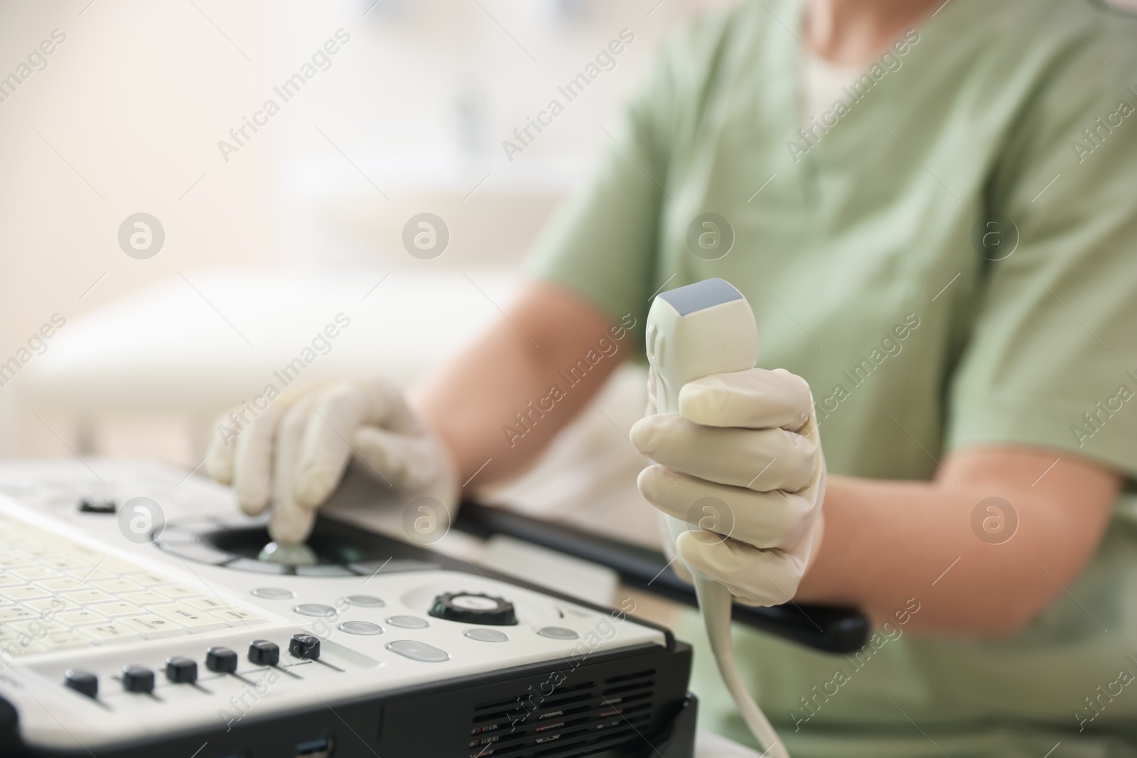 Professional sonographer with ultrasound machine in clinic, closeup Photo of Professional sonographer with ultrasound machine in clinic, closeup