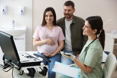 Photo of Pregnant couple attending prenatal ultrasound examination in clinic