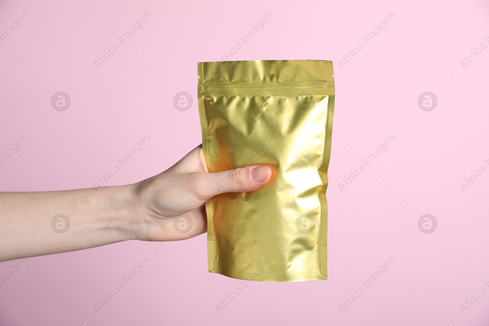 Woman with zipper stand-up pouch on pink background, closeup. Mockup for design Photo of Woman with zipper stand-up pouch on pink background, closeup. Mockup for design