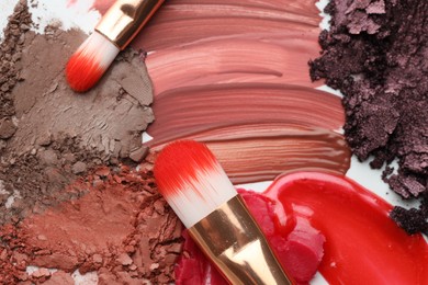 Photo of Different cosmetic products and makeup brushes on white background, flat lay