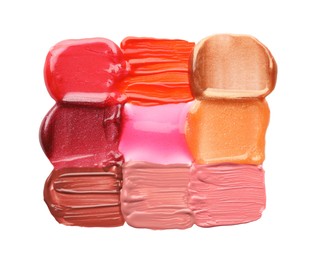 Photo of Colorful lip glosses isolated on white, top view