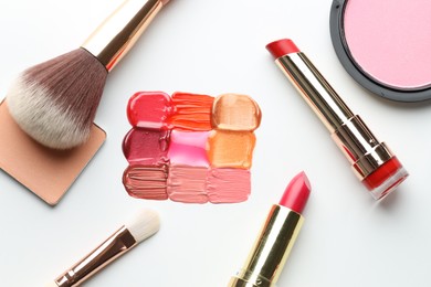 Photo of Different cosmetic products and makeup brushes on white background, flat lay