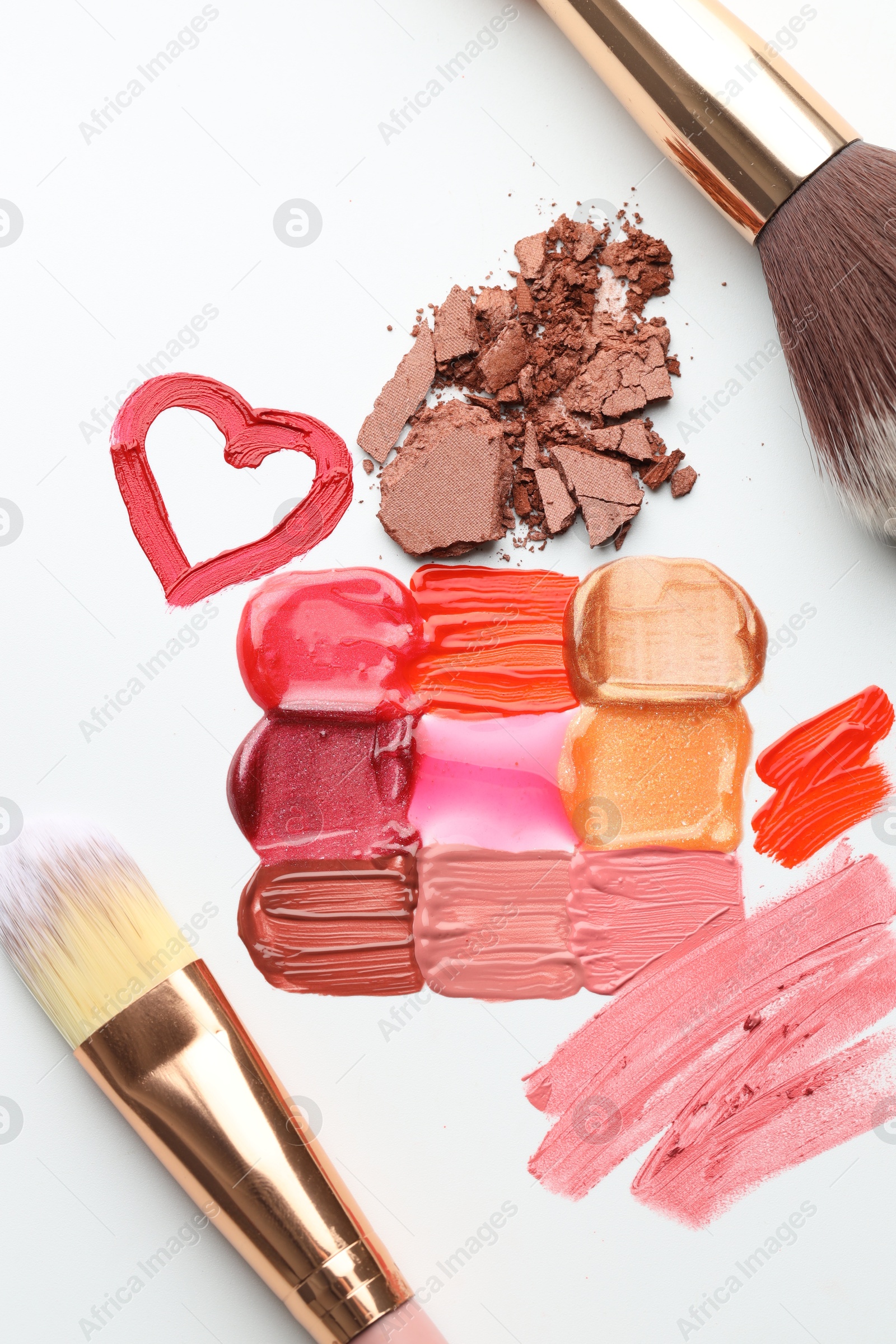 Different cosmetic products and makeup brushes on white background, flat lay Photo of Different cosmetic products and makeup brushes on white background, flat lay