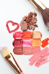 Photo of Different cosmetic products and makeup brushes on white background, flat lay