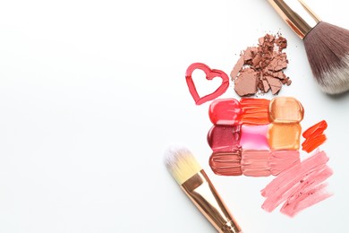 Photo of Different cosmetic products and makeup brushes on white background, flat lay. Space for text