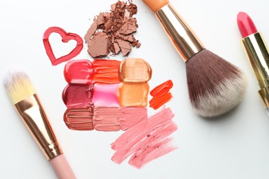 Photo of Different cosmetic products and makeup brushes on white background, flat lay