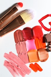 Photo of Different cosmetic products and makeup brushes on white background, flat lay