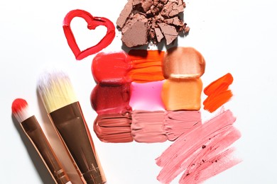 Photo of Different cosmetic products and makeup brushes on white background, flat lay