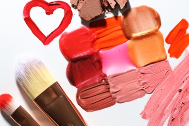 Photo of Different cosmetic products and makeup brushes on white background, flat lay