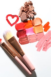 Photo of Different cosmetic products and makeup brushes on white background, flat lay