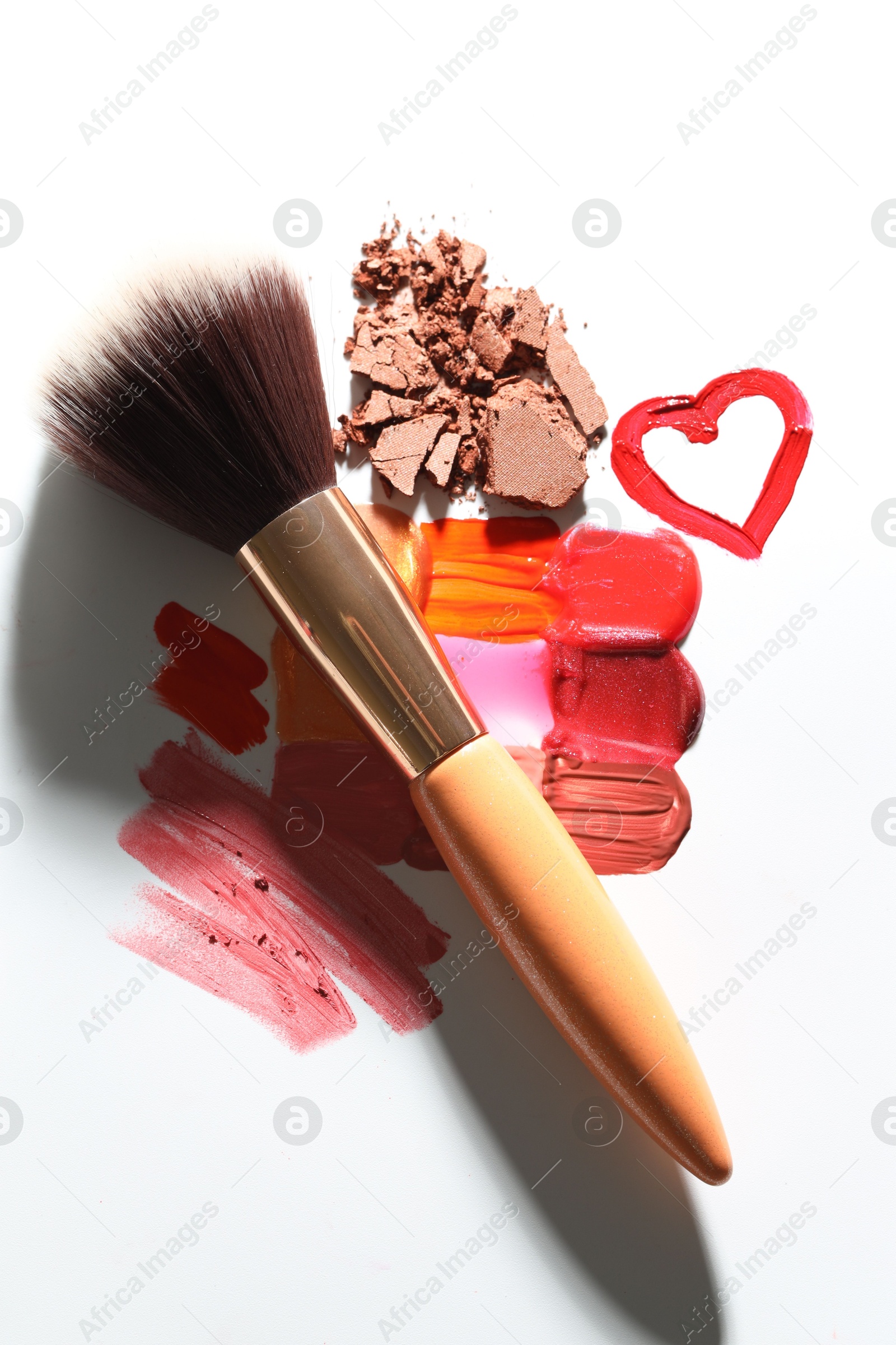 Different cosmetic products and makeup brush on white background, flat lay Photo of Different cosmetic products and makeup brush on white background, flat lay