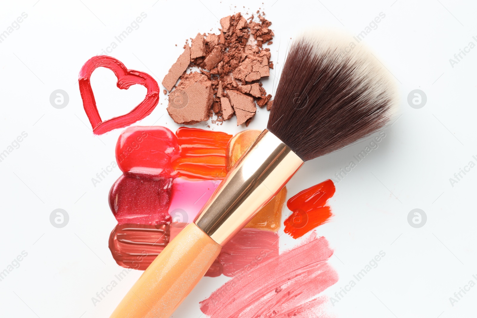 Different cosmetic products and makeup brush on white background, flat lay Photo of Different cosmetic products and makeup brush on white background, flat lay