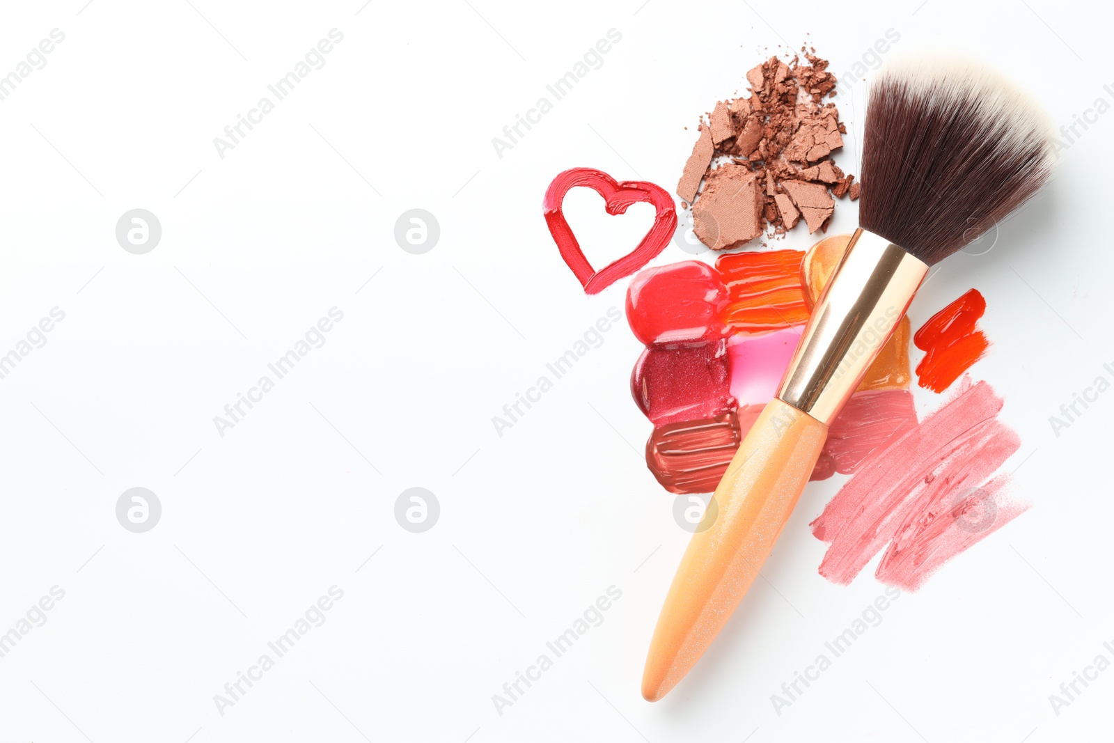 Different cosmetic products and makeup brush on white background, flat lay. Space for text Photo of Different cosmetic products and makeup brush on white background, flat lay. Space for text
