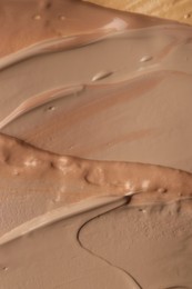 Photo of Colorful skin foundations as background, top view