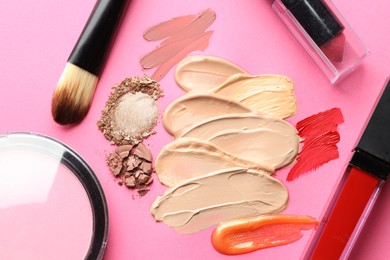 Photo of Different cosmetic products and makeup brushes on magenta background, flat lay