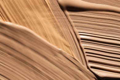 Photo of Colorful skin foundations as background, closeup view