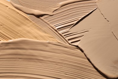 Photo of Colorful skin foundations as background, above view
