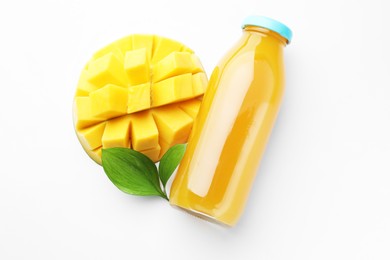 Photo of Tasty mango juice in glass bottle, fresh fruit and green leaves on white background, flat lay