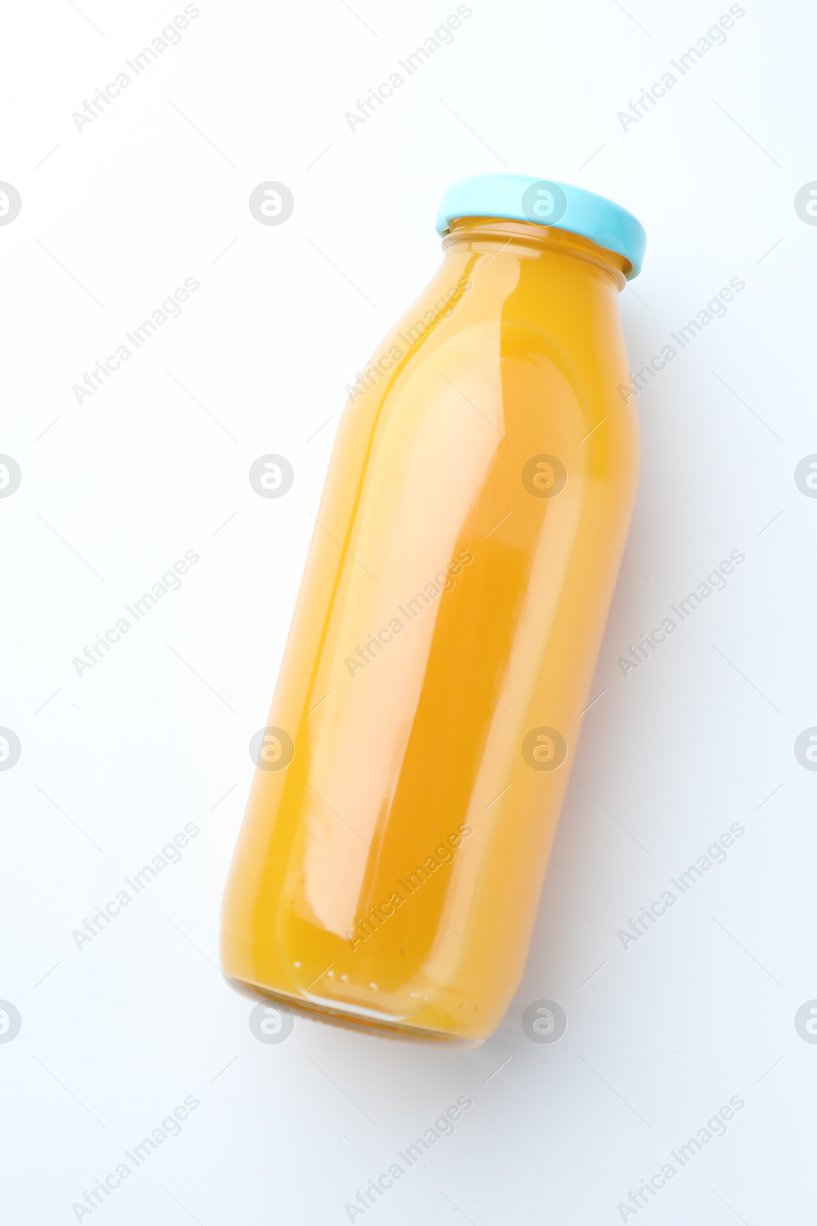 Tasty mango juice in glass bottle on white background, top view Photo of Tasty mango juice in glass bottle on white background, top view