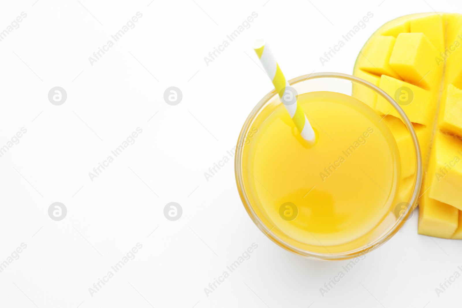 Tasty mango juice in glass and fresh fruit on white background, flat lay. Space for text Photo of Tasty mango juice in glass and fresh fruit on white background, flat lay. Space for text